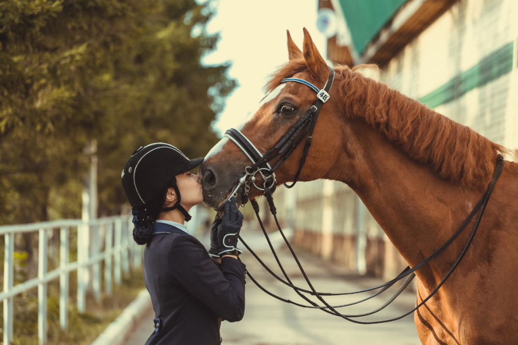 Horse and rider share a tender moment.