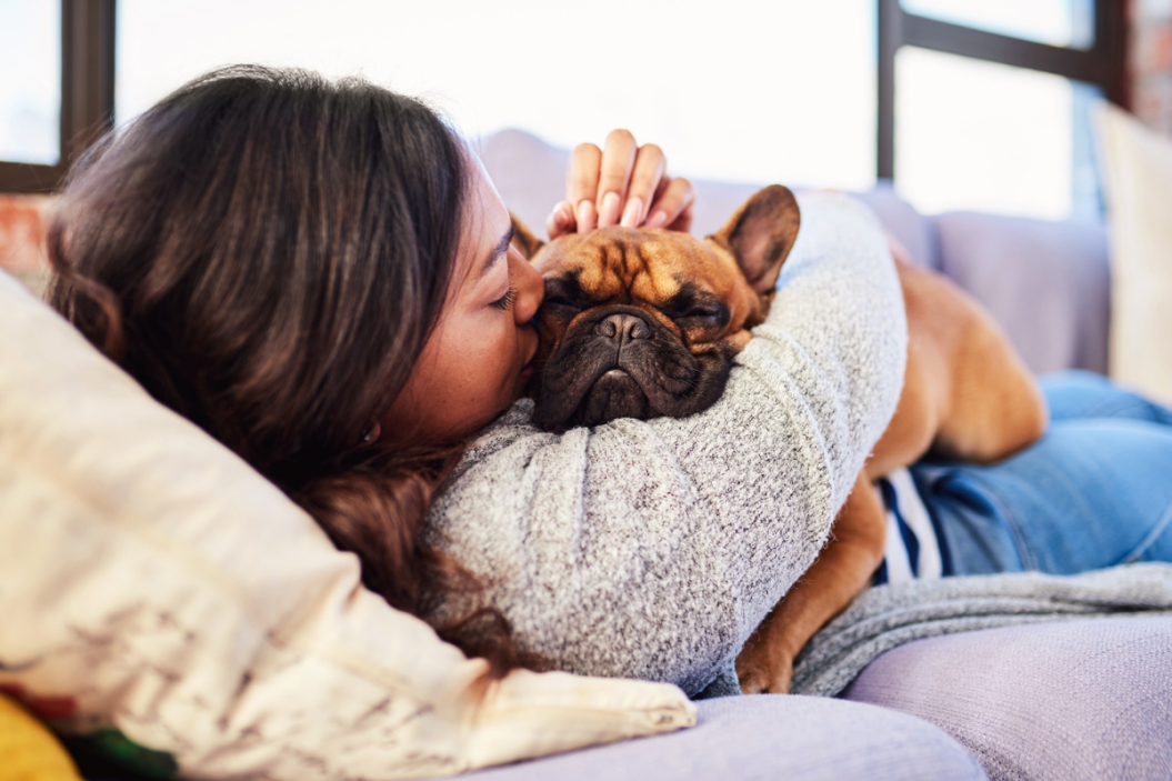 Woman cuddling emotional support dog