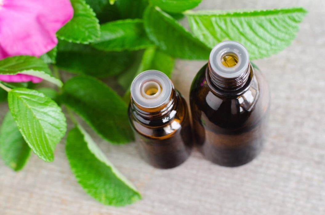 Two small bottles of natural cosmetic (essential) aroma oil for skincare and aromatherapy.